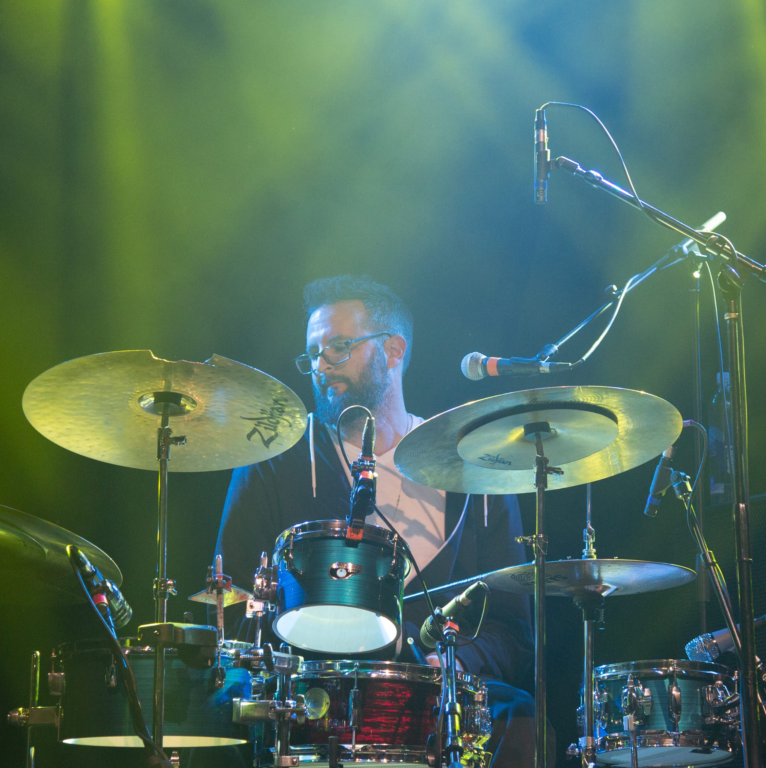 Adam Chase playing drums live on stage