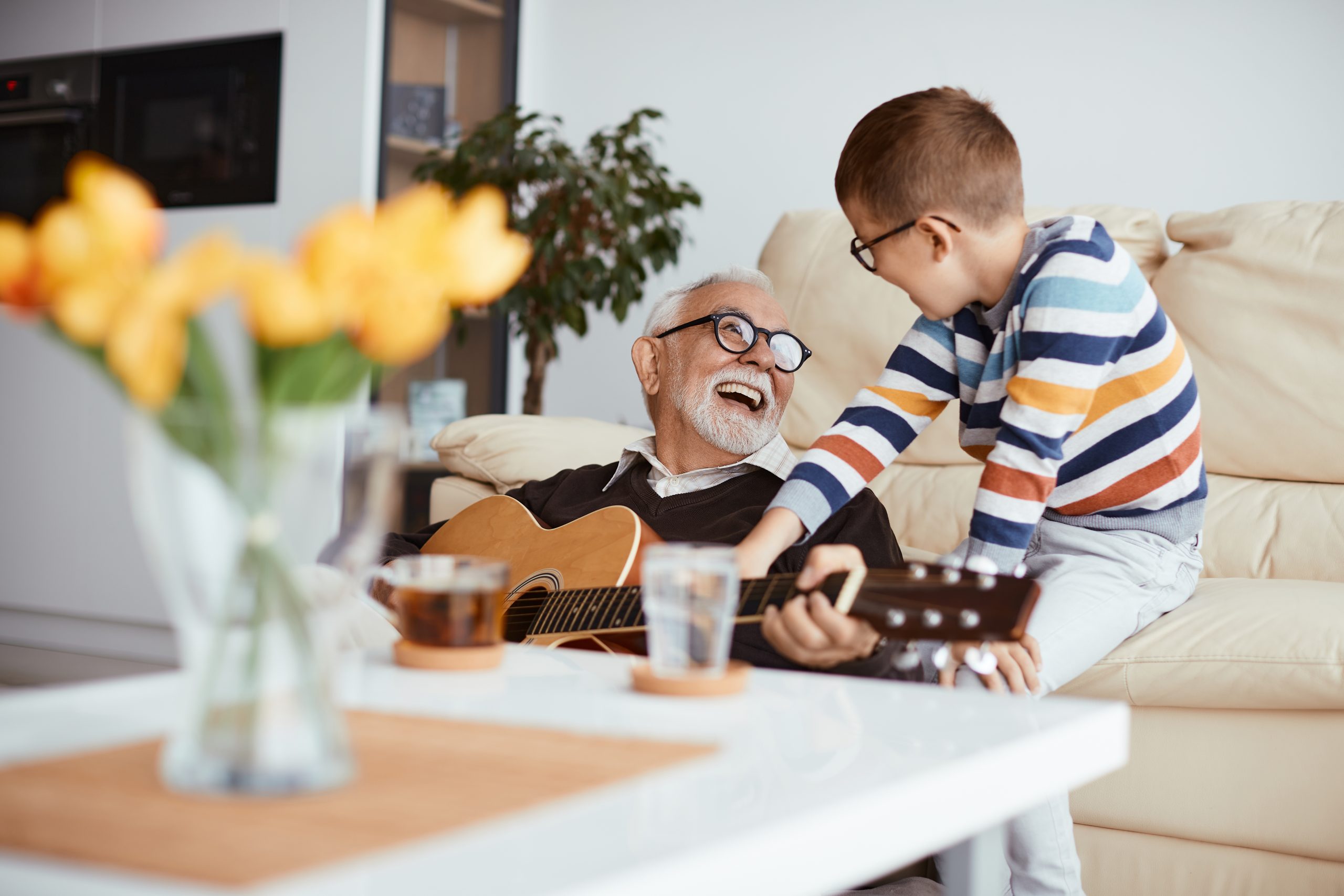 grandpa showing boy How Many Strings Does a Guitar Have