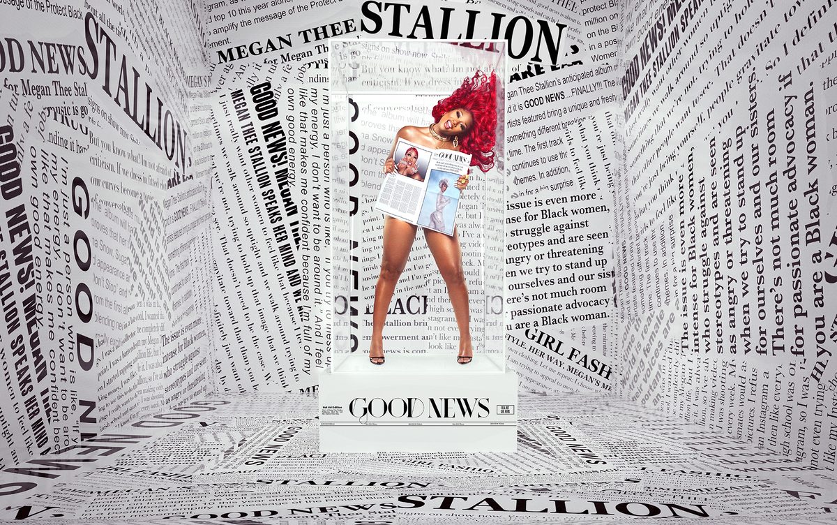 Megan Thee Stallion surrounded by newspapers