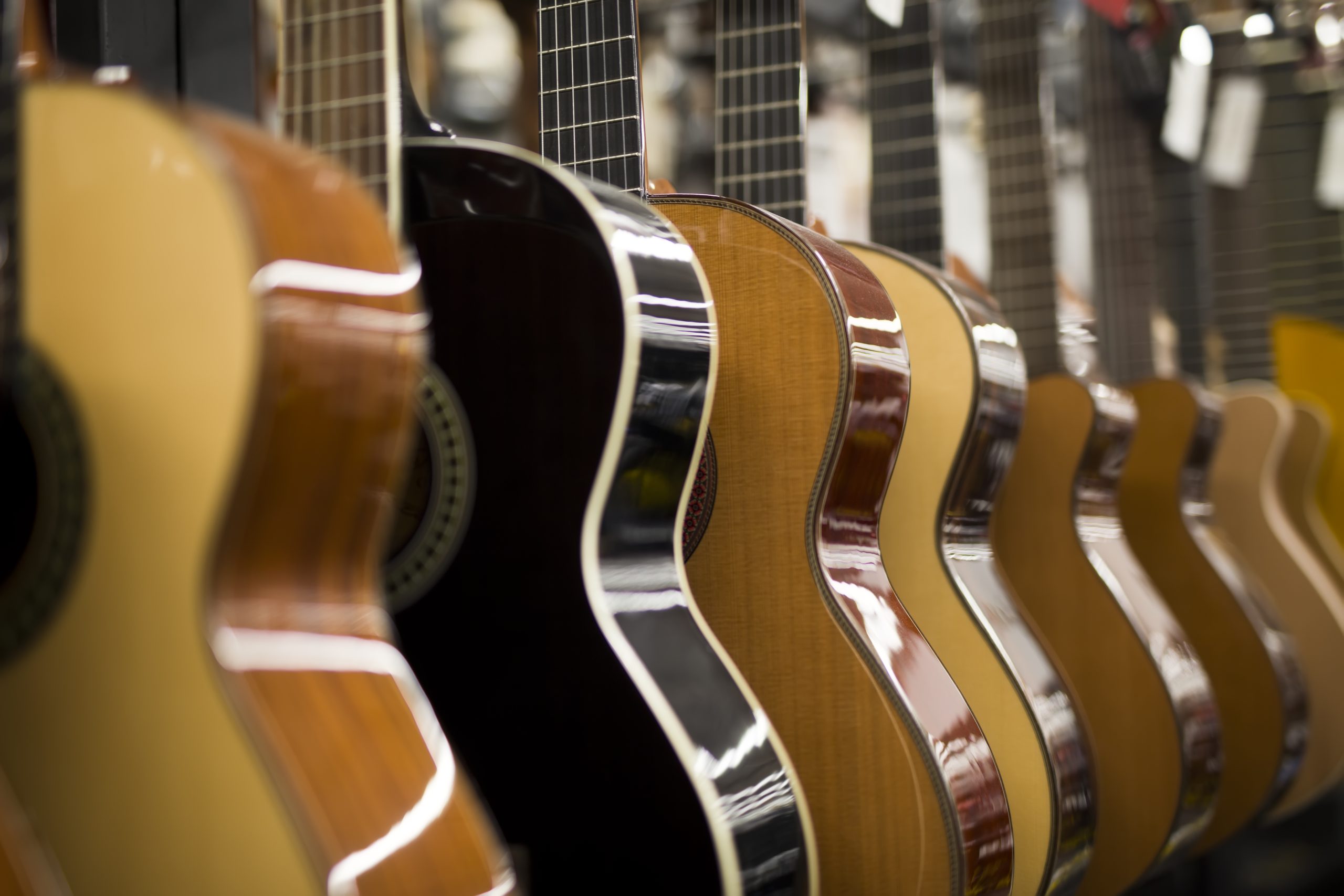 side angle of guitars hanging for what is acoustic guitar